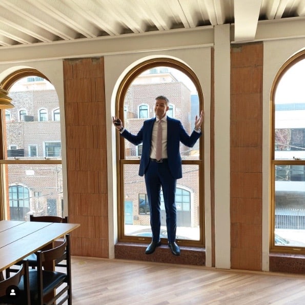 This is an image of man standing in a custom wood window in Brooklyn, New York City.