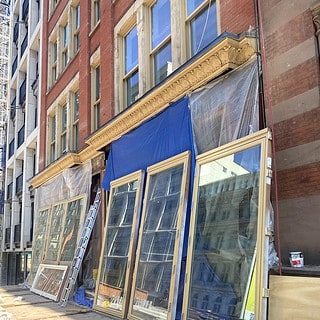 This is an image of windows ready to be installed in a building's front facade.