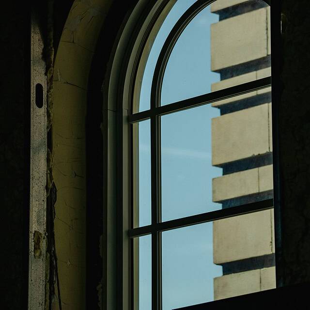 The interior of an arched top aluminum window